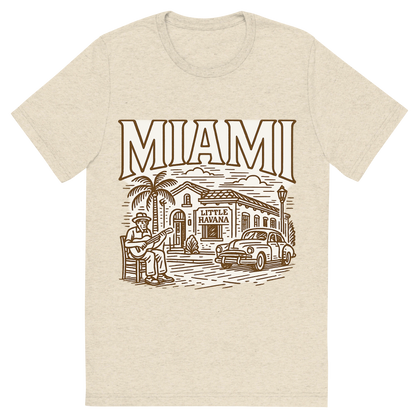 Front view of a Premium Tri-Blend Crew Neck T-Shirt in Oatmeal showing 'A typographic, nostalgic graphic of a typographic illustration of the words 'miami' with a vintage line art drawing of little havana'