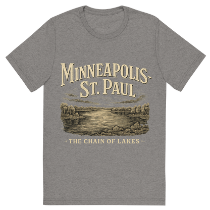 Front view of a Premium Tri-Blend Crew Neck T-Shirt in Grey showing 'A typographic, nostalgic graphic of a typographic illustration of the words 'minneapolis-st. paul' with a vintage line art drawing of the chain of lakes'
