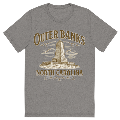 Front view of a Premium Tri-Blend Crew Neck T-Shirt in Grey showing 'A typographic, nostalgic graphic of a typographic illustration of the words 'outer banks, north carolina' with a vintage line art drawing of the wright brothers memorial'