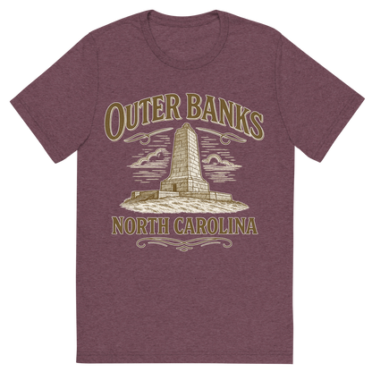 Front view of a Premium Tri-Blend Crew Neck T-Shirt in Maroon showing 'A typographic, nostalgic graphic of a typographic illustration of the words 'outer banks, north carolina' with a vintage line art drawing of the wright brothers memorial'