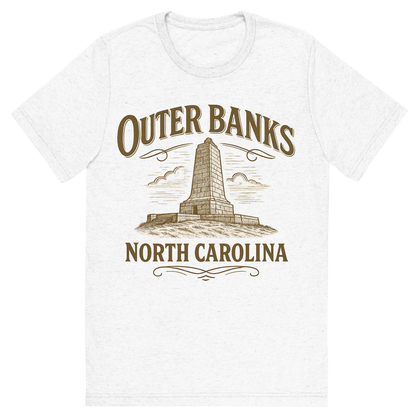 Front view of a Premium Tri-Blend Crew Neck T-Shirt in Solid White showing 'A typographic, nostalgic graphic of a typographic illustration of the words 'outer banks, north carolina' with a vintage line art drawing of the wright brothers memorial'