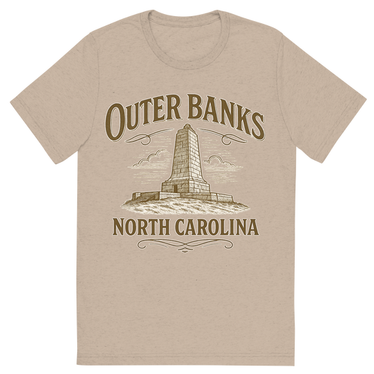 Front view of a Premium Tri-Blend Crew Neck T-Shirt in Tan showing 'A typographic, nostalgic graphic of a typographic illustration of the words 'outer banks, north carolina' with a vintage line art drawing of the wright brothers memorial'