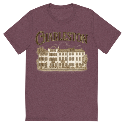 Front view of a Premium Tri-Blend Crew Neck T-Shirt in Maroon showing 'A typographic, nostalgic graphic of a typographic illustration of the words 'charleston' with a vintage line art drawing of the rainbow row'