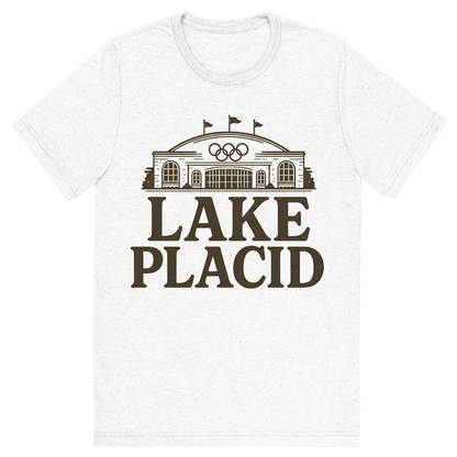 Front view of a Premium Tri-Blend Crew Neck T-Shirt in Solid White showing 'A typographic, nostalgic graphic of a typographic illustration of the words 'lake placid' with a vintage line art drawing of the olympic center'