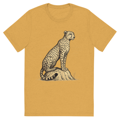 Front view of a Premium Tri-Blend Crew Neck T-Shirt in Mustard showing 'A hand-drawn ink with color pops, focused graphic of a sleek cheetah perched atop a termite mound, scanning the horizon with alert eyes, illustrated in hand-drawn ink with soft tan and black details, centered composition, transparent background, optimized for dtg printing'